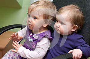 Two baby girls in chair