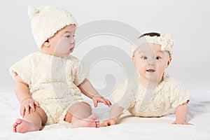 Two baby in white fur dress in