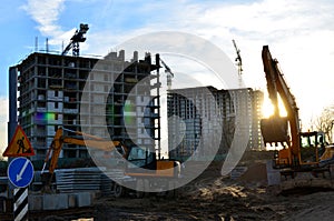 Two backhoe loaders during excavation work on the construction site