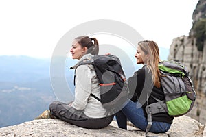 Two backpackers contemplating views in the mountain