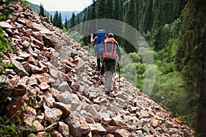 Two backpackers in mountains