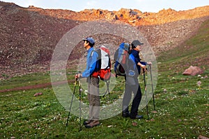 Two backpackers in mountains