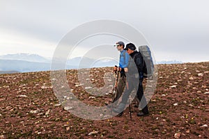 Two backpackers in mountains