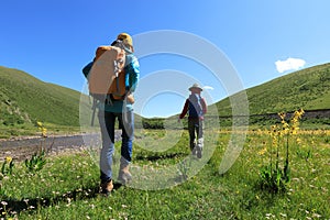 Two backpacking female friends hiking