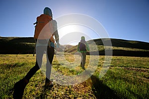 Two backpacking women hiking