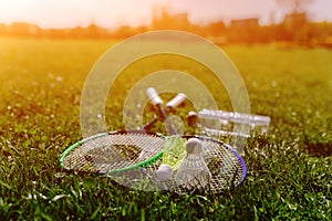 Two badminton rackets and a bottle of water shot