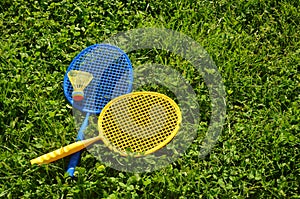 Two badminton rackets on the green grass