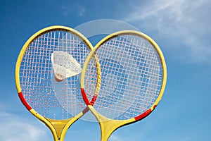 Two badminton rackets and shuttlecock flying