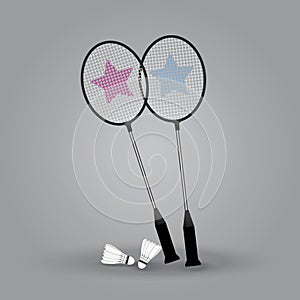 Two badminton rackets with shuttlecock on gray background.