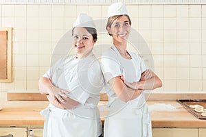 Two baker women standing proud in their bakery