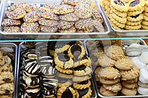 Two bakery shelves containing a variety of cookies