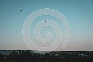 Two balloons fly at dawn