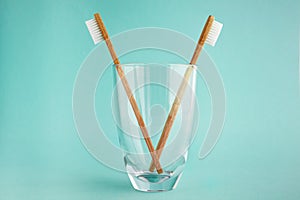 Two bamboo toothbrushes in a glass