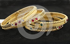 Two Bangles Or Kadas Or Kangan places on a surface being focused