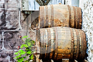 Two barrels are leaning against a wall