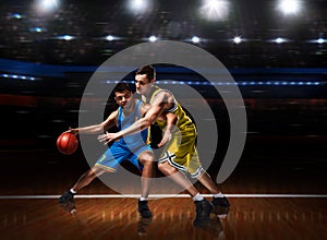 Two basketball players in scrimmage during basketball match