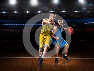 Two basketball players in scrimmage during basketball match photo