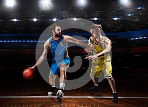 Two basketball players in scrimmage during basketball match photo