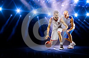 Two basketball players in spotlights