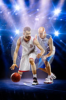Two basketball players in spotlights