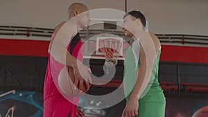 Two basketball players standing face to face