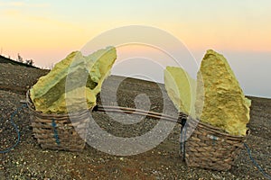 Two baskets with big pieces of the heavy sulphur from the Ijen Volcano