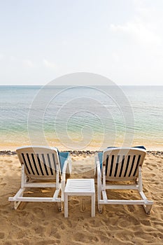 Two beach chairs at an empty beach in Thailand