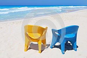 Two beach chairs at paradise sea coast