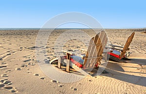 Two beach chairs sitting in the sand