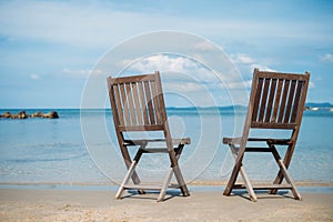 Two beach chairs on tropical shore