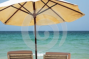 Two beach chairs and umbrella against seascape. Inspirational summertime rest