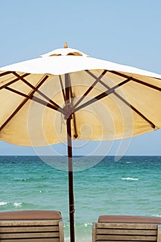Two beach chairs and umbrella against seascape. Inspirational summertime rest