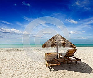 Two beach lounge chairs under tent