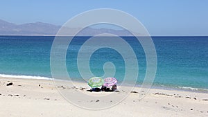 Two beach umbrellas on the shore of the Sea of Cortes, Punta Arena de La Ventana, BCS, Mexico photo