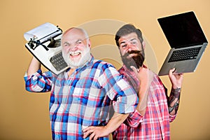 Two bearded men. Vintage typewriter. youth vs old age. business approach. technology generation battle. Modern life