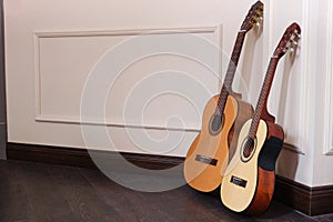 Two beautiful acoustic guitars on the floor