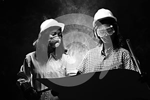 Two Beautiful Asian Architect Engineer women in hard hat, protector glasses goggle mask ear
