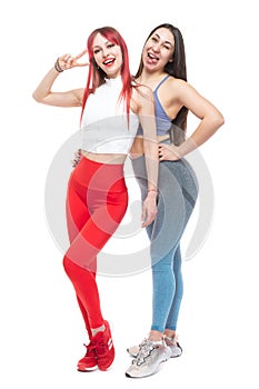 Two beautiful, athletic, slim and cheerful female friends are smiling. In full growth. Lifestyle concept with sports and