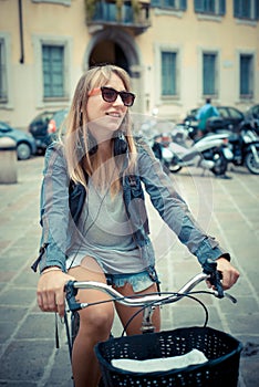 Two beautiful blonde women shopping on bike