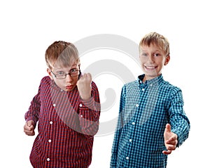 Two beautiful boys in colorful shirts showing gestures of aggression and welcome