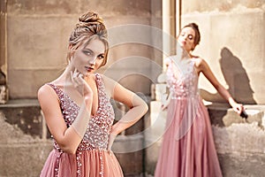 Two beautiful bridesmaids in gorgeous elegant stylish red pink violet floor length v neck chiffon gown dress decorated