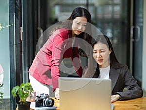 Two of beautiful businesswomen having webinar online conference meeting