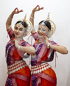 Two Beautiful Classical Odissi dancers performing Odissi Dance on stage at Konark Temple, Odisha, India.