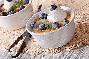 Two beautiful dessert cream brulee with blueberries. horizontal