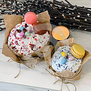 Two beautiful eastercakes decorated with colored chocolate eggs and macaroons