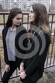 two beautiful fashion girl on the street, the atmosphere