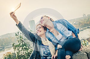 Two beautiful friends making selfie