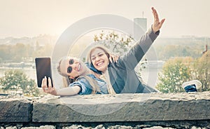 Two beautiful friends making selfie