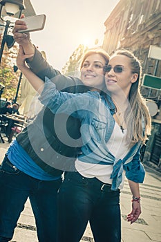 Two beautiful friends making selfie