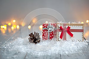 Two beautiful gifts with bows on wooden background in Christmas concept
